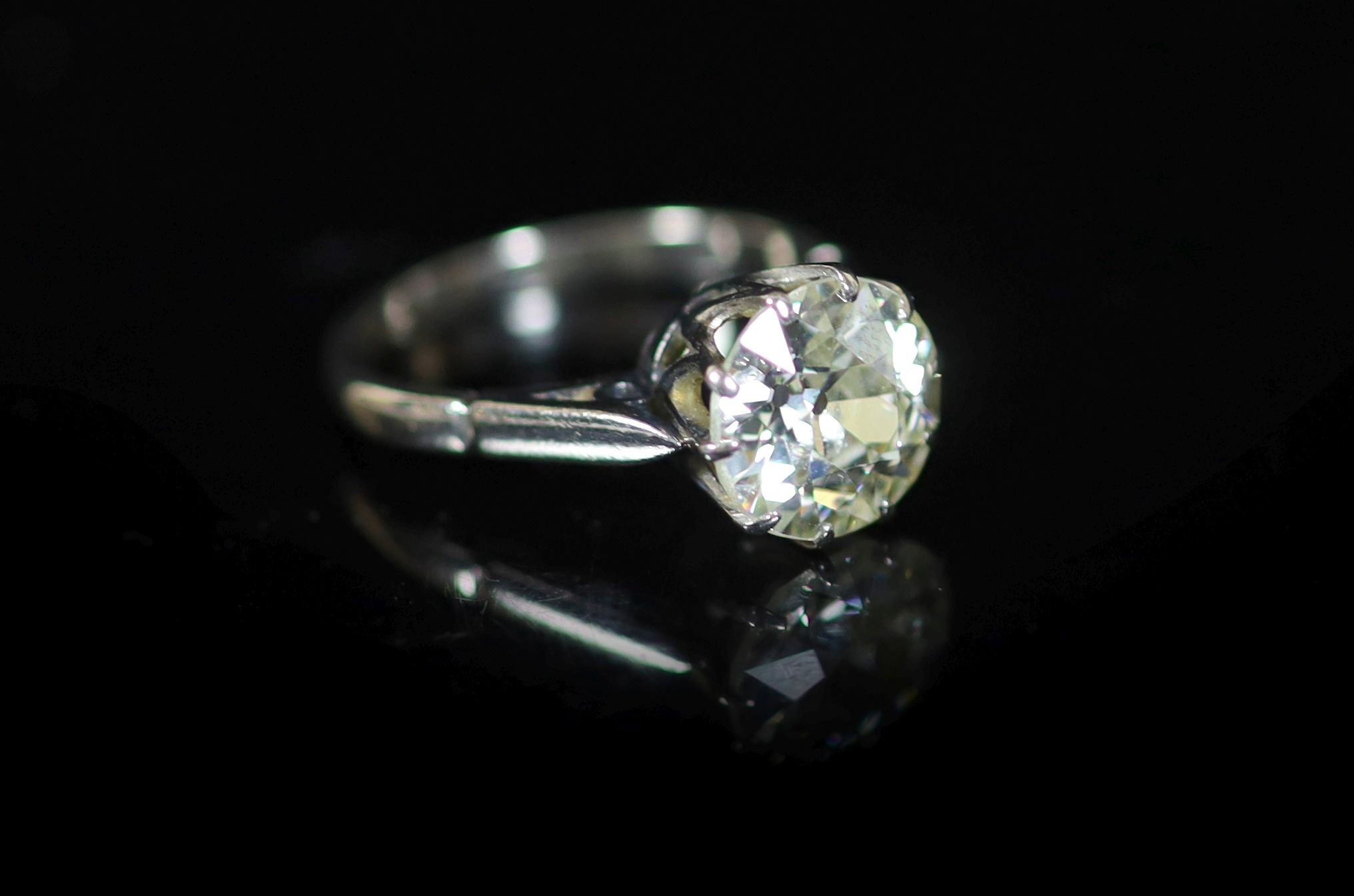 A platinum and solitaire diamond ring